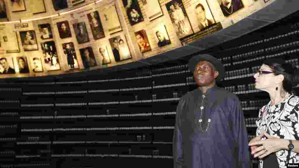 President Jonathan stands under pictures of Jews killed in the Holocaust during a visit to the Hall of Names at Yad Vashem's Holocaust History Museum in Jerusalem.