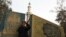 A man standing in front of Moqattam mosque takes a photo near the Muslim Brotherhood's national headquarters in Cairo's Moqattam district March 22, 2013.