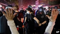 Police arrest protesters as they march through the streets of Manhattan, New York, June 3, 2020.