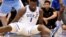 FILE - Duke's Zion Williamson sits on the floor after his shoe split open during the first half of an NCAA college basketball game against North Carolina in Durham, N.C., Feb. 20, 2019.