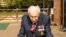 A handout photo taken in April 2020 shows World War II veteran Capt. Tom Moore, 99, walking in his garden  in Marston Moretaine, north of London. AFP PHOTO / MAYTRIX GROUP / HANDOUT