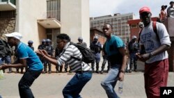 South Africa University Protests: Protesting students from the University of the Witswatersrand sing outside the Hillbrow Magistrate’s Court in Johannesburg, South Africa, Wednesday, Oct. 12, 2016, in support of their peers who were arrested earlier this week.