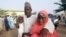 FILE—Parents are reunited with their daughters in Jangabe, Nigeria, March 3, 2021. 