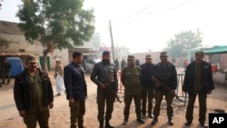 Pakistani police officers stand guard outside Multan jail after a court convicted Muslim professor Junaid Hafeez of blasphemy, sentencing him to death, in Multan, Pakistan, Dec. 21, 2019.