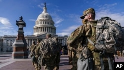 FILE - National Guard troops reinforce security around the U.S. Capitol ahead of expected protests leading up to Joe Biden's inauguration as president, in Washington, Jan. 17, 2021.