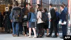 FILE - A group of students enters the building that houses the Russian Mission to the United Nations in New York for a tour, March 26, 2018. Russia is urging about 60,000 of its citizens studying abroad to return home.