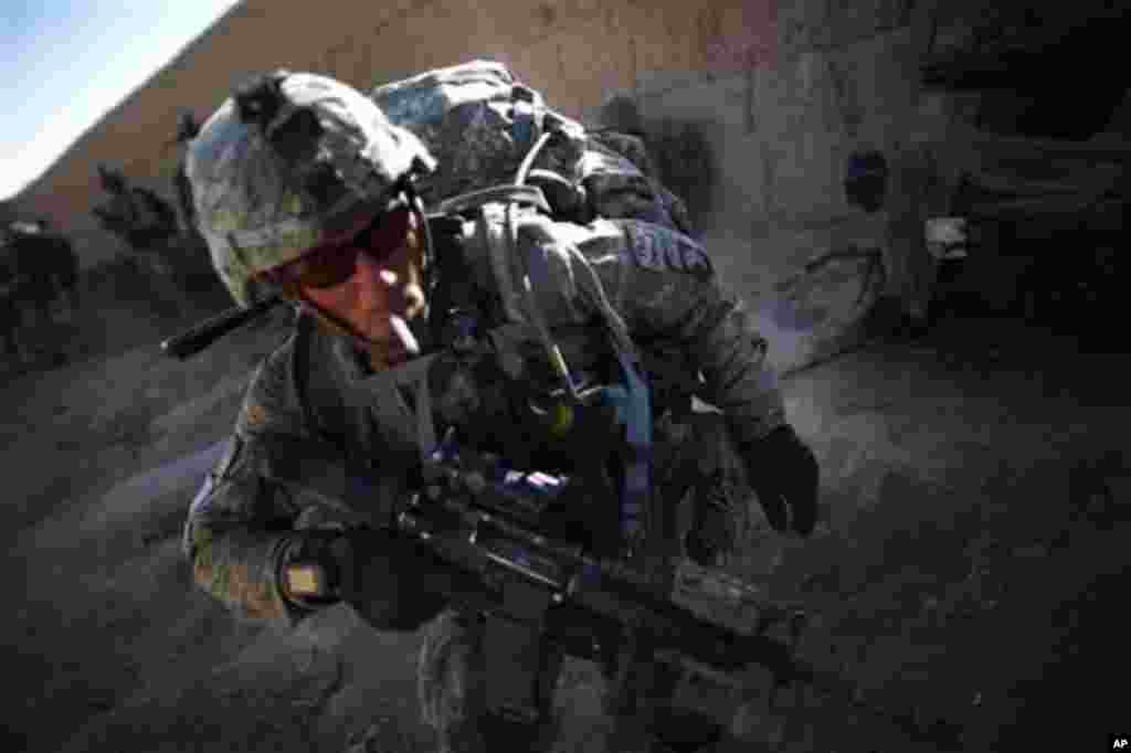 US soldier Sergeant Bill Myers, from Phoenix, Arizona, from Bravo Company 2-502 Infantry Regiment, 101st Airborne Division, prepares to patrol after a break near Forward Operation Base Howz-e-Madad, Zhari district, Kandahar province, Afghanistan, Thursday