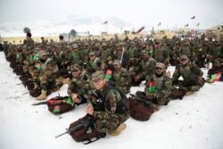 FILE - Afghan Army commandos attend their graduation ceremony after a 3 1/2 month training program at the Commando Training Center, on the outskirts of Kabul, Afghanistan, Jan. 13, 2020.
