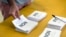 A man prepares to cast his vote at a polling station in Noumea, New Caledonia, as part of an independence referendum, Nov. 4, 2018. 