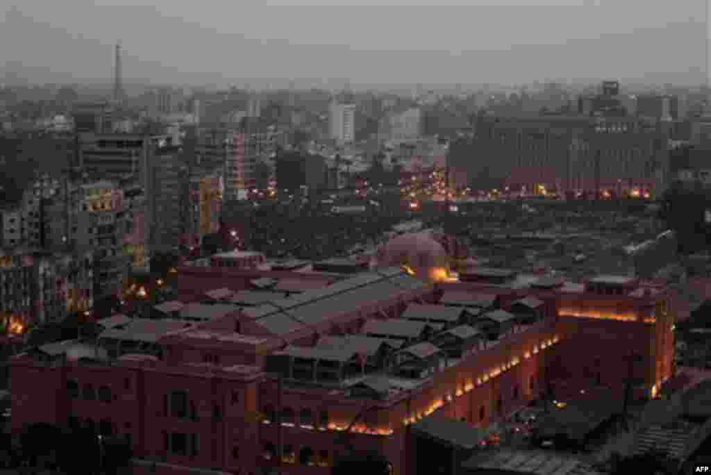 Seen over the roofs of the Egyptian Museum, a crowd remains late afternoon in Tahrir, or Liberation, Square in Cairo, Egypt, Tuesday, Feb. 1, 2011. More than a quarter-million people flooded into the heart of Cairo Tuesday, filling the city's main squar