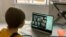A school kid socializes with peers online following school closures due the spread of the coronavirus disease (COVID-19) outbreak, in London, Britain, March 20, 2020 in this picture obtained from social media on March 25, 2020. Anais Aguerre/via…