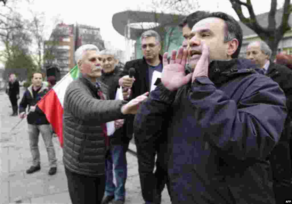 Demonstrators shout slogans towards the Iranian embassy, as they protest to show solidarity to the people of Iran and others fighting for freedom, in Brussels, Monday, Feb. 14, 2011. (AP Photo/Yves Logghe)