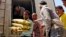 A Yemeni volunteer carries bags of rice to displaced people, who fled fighting in the southern city of Aden, during a food distribution effort in Taiz, Yemen, May 9, 2015.