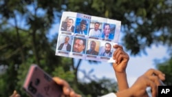 FILE — Oromos call for the release of prominent opposition figure Jawar Mohammed and others, seen on placards, in Addis Ababa, Ethiopia on Oct. 2, 2021. Ethiopia's government on Jan. 7, 2022 announced an amnesty for some of the country's most high-profile political detainees.