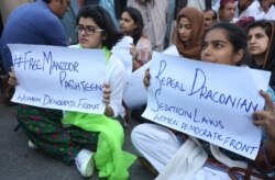 Women protest demanding the release of human rights activist Manzoor Pashteen, in Karachi, Pakistan, Jan. 28, 2020.
