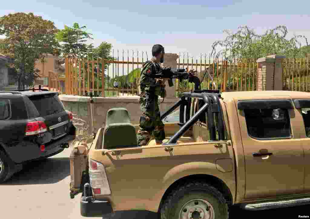 An Afghan soldier stands in a military vehicle on a street in Kabul, Aug. 15, 2021.