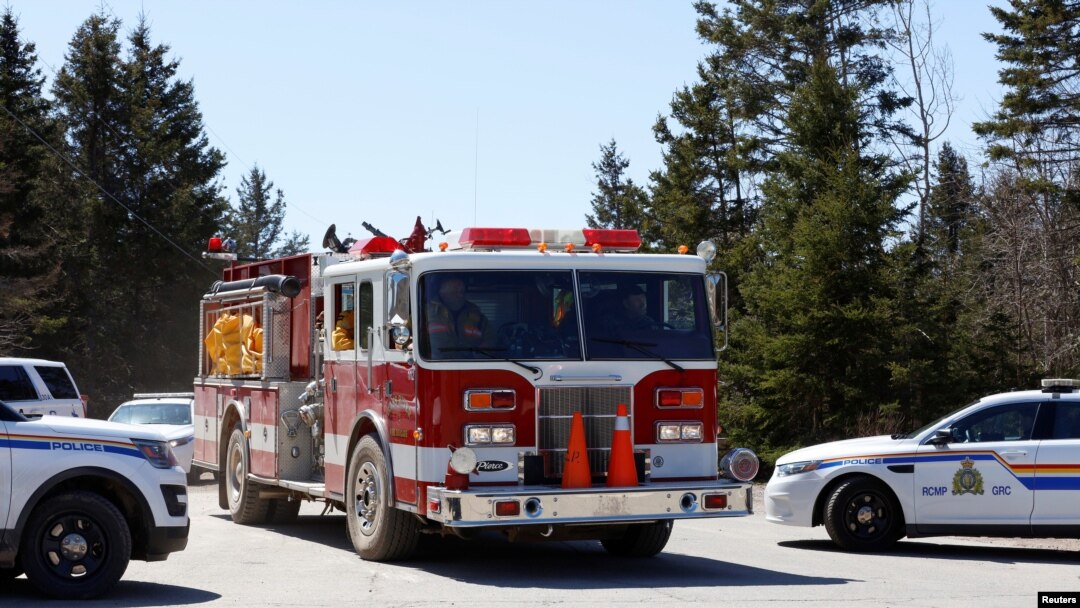 Royal Canadian Mounted Police (RCMP) monitor Portapique Beach Road, as a fire truck travels along it after searching for Gabriel Wortman, who the police describe as a shooter of multiple victims, in Portapique, Nova Scotia, Canada April 19, 2020. 