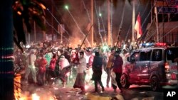 Fire crackers explode near supporters of presidential candidate Prabowo Subianto during clashes with the police in Jakarta, Indonesia, May 22, 2019. 