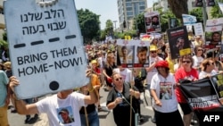 (FILE) Demonstrators march during a protest by the mothers and relatives of Israelis held hostage by Palestinian militants in Gaza since the October 7 attacks, calling for efforts to save the hostages, in Tel Aviv on July 5, 2024.