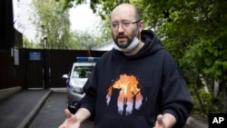 Prominent Russian journalist Ilya Azar, who was sentenced for holding a one-person protest amid lockdown, gestures while speaking to the media shortly after his release in Moscow, Russia, June 7, 2020.