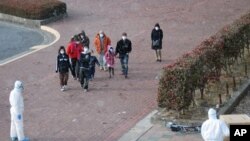 People walking towards a radiation screening center, Koriyama, Japan, March 17, 2011.