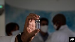 Un médico muestra un frasco vacío de la vacuna experimental Soberana 02 para COVID-19 que se está desarrollando en el Centro de Inmunidad Molecular durante un recorrido por los medios de comunicación de la instalación en La Habana, Cuba. Febrero 25, 2021.