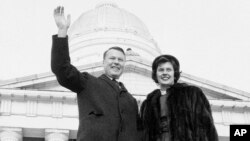 FILE - Philip H. Hoff and wife Joan wave in front of the Vermont State House as he became the first democratic governor in over 100 years in Montpelier, Vt. 