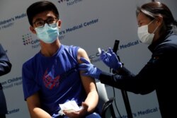 Thomas Lo, 15, receives a dose of the Pfizer-BioNTech vaccine for the coronavirus disease at Northwell Health's Cohen Children's Medical Center in New Hyde Park, New York, May 13, 2021.