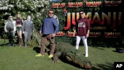 Actors Jack Black, left, and Nick Jonas pose to the media during a photocall to promote the film "Jumanji: Welcome to the jungle" in Barcelona, Spain, June 18, 2017.