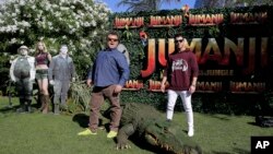 FILE - Actors Jack Black, left, and Nick Jonas promote the film "Jumanji: Welcome to the Jungle" in Barcelona, Spain, June 18, 2017.