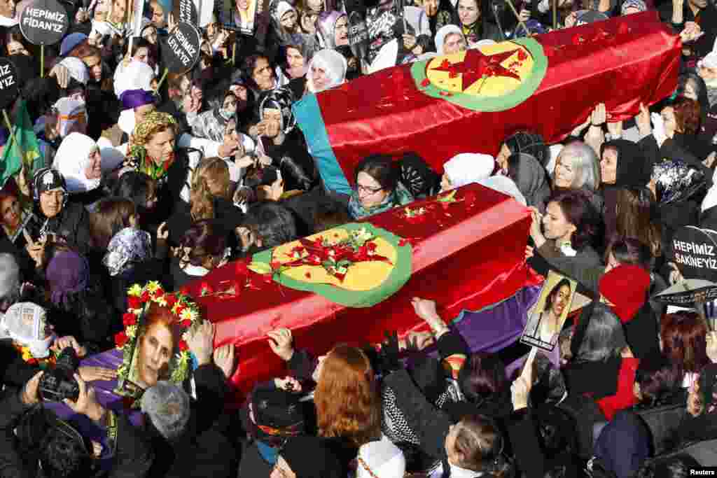 People carry the coffins of the Kurdish activists, who were shot in Paris, during a funeral ceremony in Diyarbakir, the largest city in Turkey's mainly Kurdish southeast.