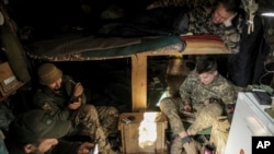 Servicemen of the 24th Mechanized Brigade rest on their position in Chasiv Yar, Donetsk region, Ukraine, Oct. 23, 2024. (Ukrainian 24th Mechanised Brigade via AP)