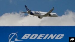 In this June 17, 2019, file photo, an Airbus A 350 - 1000 performs a demonstration flight at Paris Air Show in Le Bourget, east of Paris, France.(AP Photo/Michel Euler, FILE) 