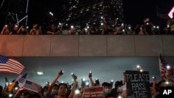 Protestors light their torches during a peaceful rally in central Hong Kong's business district, Oct. 14, 2019. 