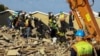 Rescuers work to rescue construction workers trapped under a building that collapsed in George, South Africa May 7, 2024.