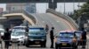 A police officer controls a car at a roadblock to restrict inter-city movement during partial lockdown to slow the spread of the coronavirus disease (COVID-19), in Circle neighborhood of Accra, Ghana, March 31, 2020.