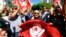 Anti-government protesters wave Tunisian flags as they rally for the dissolution of the Islamist-led government in Sfax, southeast of Tunis, Sept. 26, 2013. 
