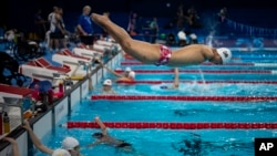 Yuan Weiyi, from China, jumps into the pool during a training session ahead of the 2024 Paralympics, Aug. 27, 2024, in Paris, France.