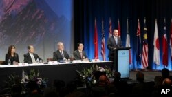 New Zealand Prime Minister John Key, right, speaks to delegates at the signing of the Trans-Pacific Partnership agreement in Auckland, New Zealand, Feb. 4, 2016. 