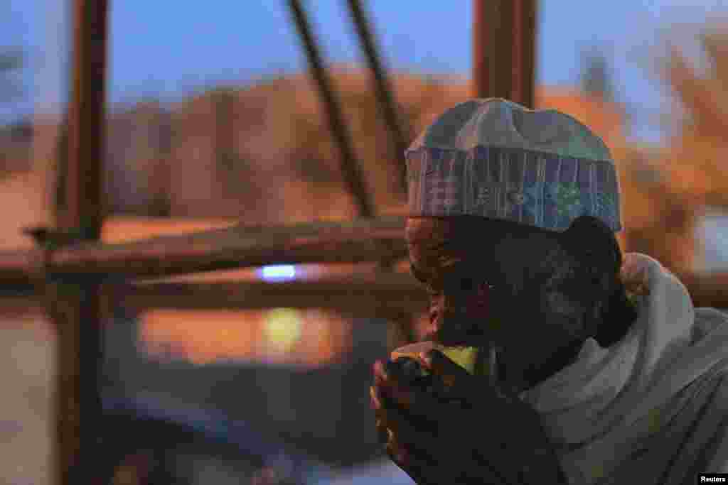 A man sucks on an orange as he breaks fast during the Islamic holy month of Ramadan at Nasfat Mosque in Utako, Abuja.