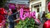 A balloon spelling out "LOVE" is added to a plant at an Egyptian flower shop. (H. Elrasam/VOA)