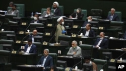 Lawmakers listen to a speech during the inauguration ceremony of Iran's new parliament, in Tehran, Iran, May, 27, 2020.