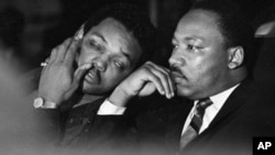 FILE - Dr. Martin Luther King, Jr. is seen here with Rev. Jesse Jackson (L) just prior to his final public appearance to address striking Memphis sanitation workers, April 4, 1968. 