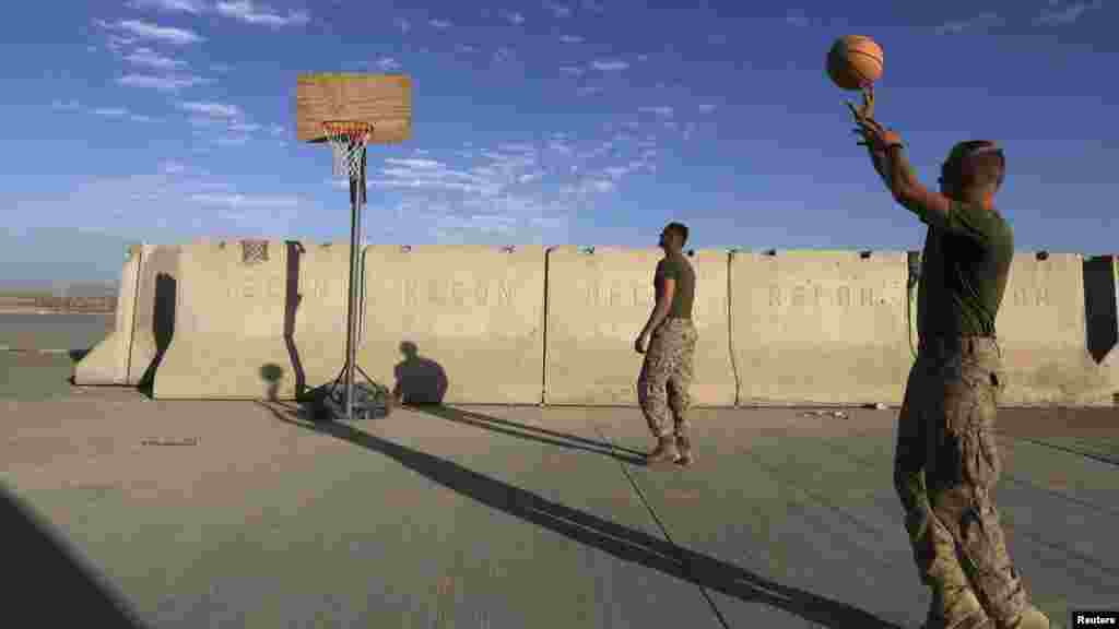 U.S. Marine troops play basketball before their withdrawal from the base, at Camp Bastion in Helmand province, Oct. 25, 2014. 