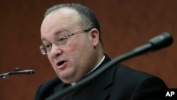 FILE - Monsignor Charles Scicluna, who was consercrated bishop in November 2012, speaks before journalists in Rome, Italy, Feb. 8, 2012.