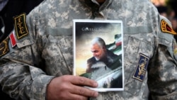 A demonstrator holds a picture of Qassem Soleimani, the assassinated head of the elite Quds Force, in Tehran, Iran, Jan. 3, 2020.