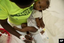 A baby stricken with cholera receives treatment at a clinic run by Doctors Without Borders in Port-au-Prince, Haiti, Friday, Nov. 11, 2022.