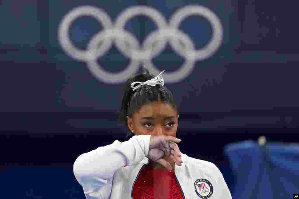 Simone Biles of the United States watches gymnasts perform at the 2020 Summer Olympics, in Tokyo. Biles says she wasn&#39;t in right &quot;headspace&quot; to compete and withdrew from the gymnastics team final. 