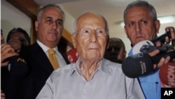 FILE - Kenan Evren, center, casts his ballot during a referendum in Ankara, Turkey, Sept. 12, 2010.