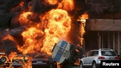 Burning vehicles are seen at the site of a fire in Almaty June 27, 2013. A 16-ton tanker rolled over after an accident and set ablaze parked cars and a nearby apartment building, Emergency Ministry reported. REUTERS/Sergey Khodanov (KAZAKHSTAN - Tags: DIS